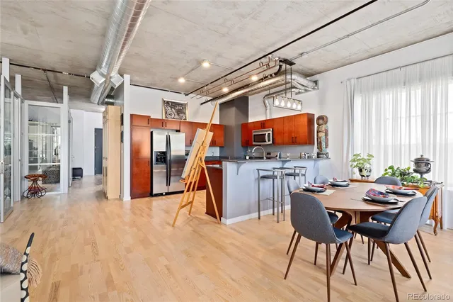 a dining room with furniture and a flat screen tv