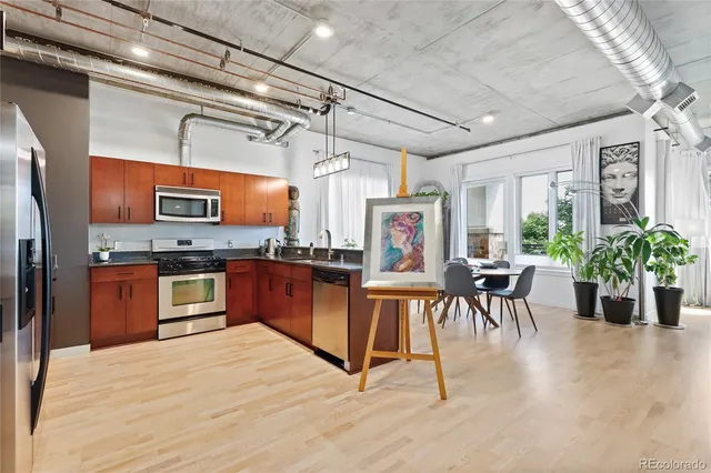 a kitchen with stainless steel appliances granite countertop a stove top oven a sink a counter top space and cabinets