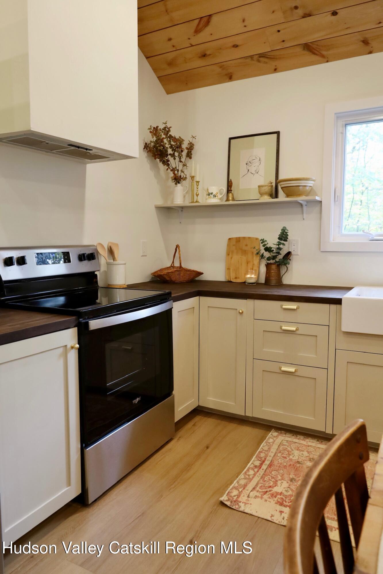 230 Potic Mountain Road Athens, NY 12414 - Photo 7 of 25 a kitchen with a stove and white cabinets