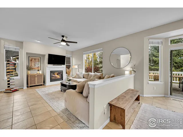 a living room with furniture and view of kitchen