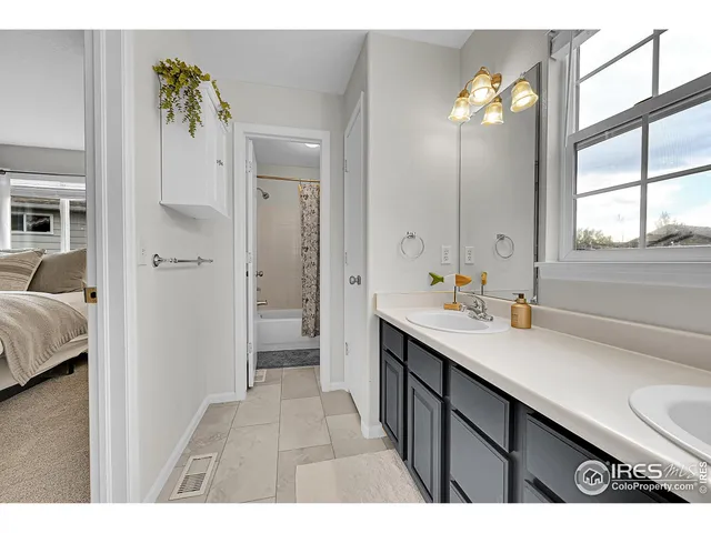 a view of a house with a big yard potted plants and large tree