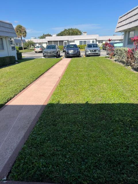 80 Valencia C, Unit D Delray Beach, FL 33446 - Photo 12 of 14 a view of outdoor space with deck and yard