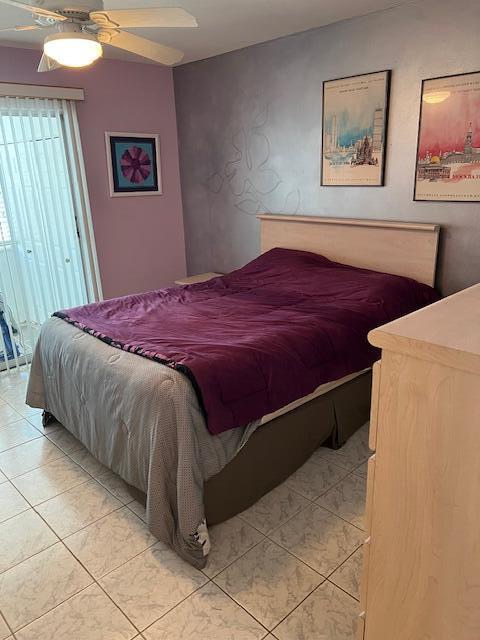 80 Valencia C, Unit D Delray Beach, FL 33446 - Photo 8 of 14 a bedroom with a bed and a painting on the wall