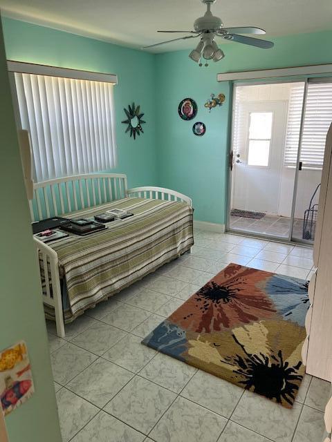 80 Valencia C, Unit D Delray Beach, FL 33446 - Photo 9 of 14 a bedroom with a bed and a window