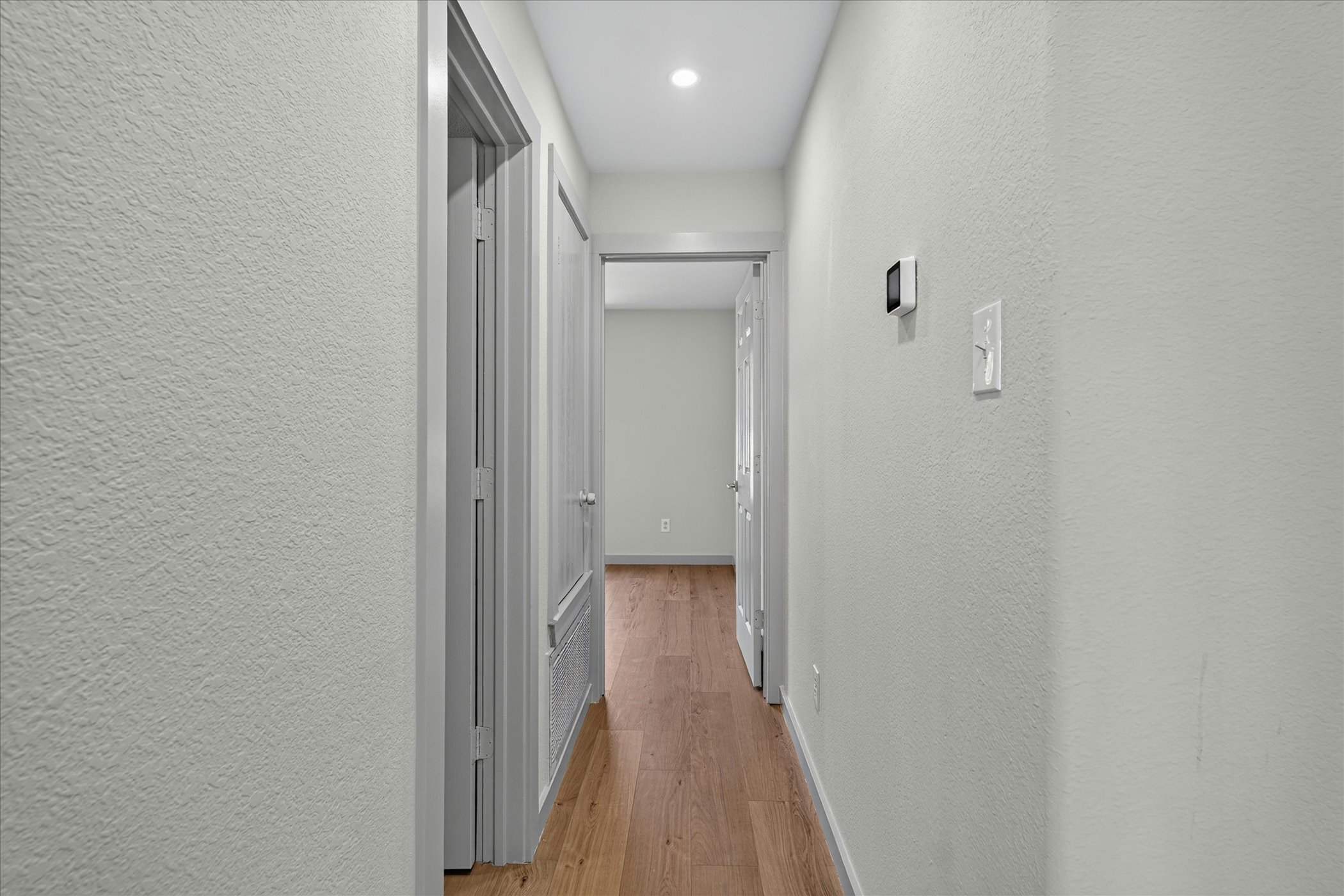 258 Pine View Loop Bastrop, TX 78602 - Photo 35 of 40 Clean lines and a luminous ceiling light illuminate this inviting interior hallway.