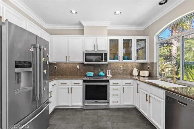 a kitchen with a sink stove and refrigerator