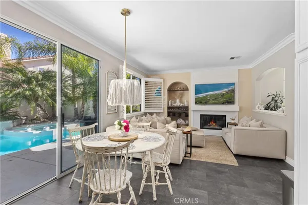 a view of a dining room with furniture large windows and wooden floor