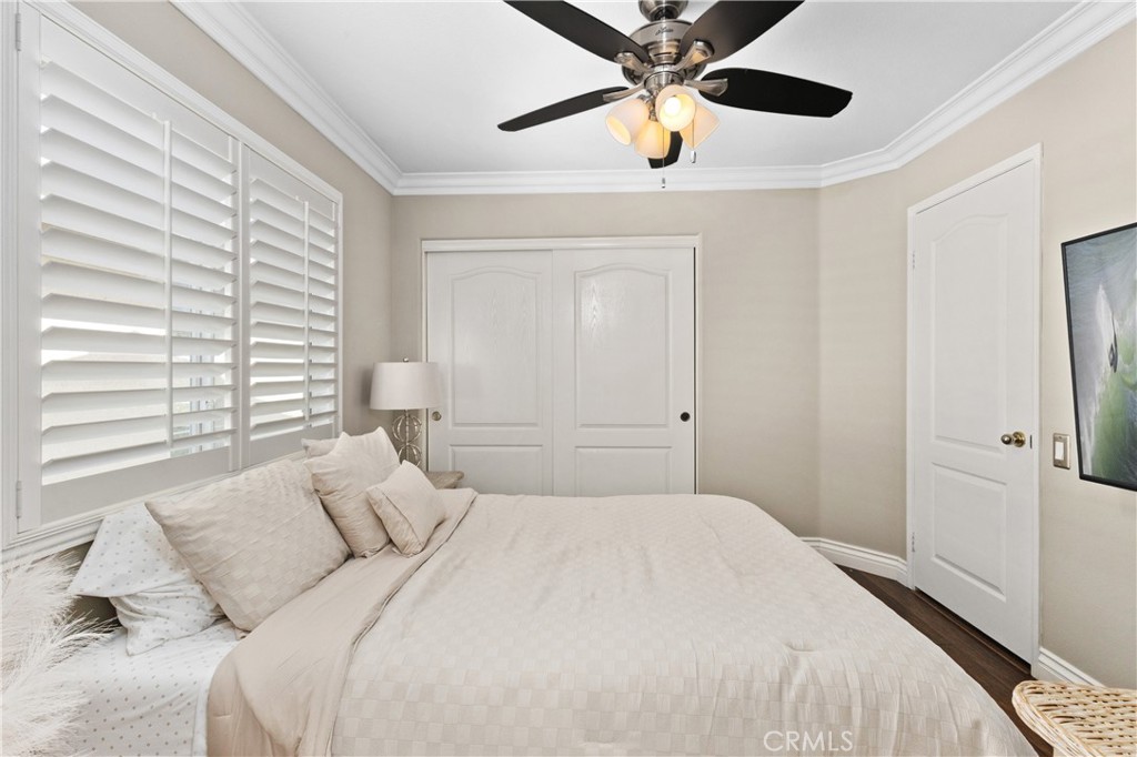 13668 Kingsbridge Street Westminster, CA 92683 - Photo 16 of 36 a bedroom with a bed and a chandelier