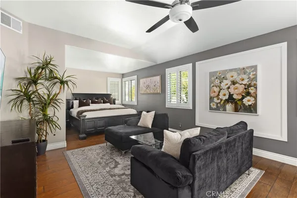 a living room with furniture ceiling fan and a rug