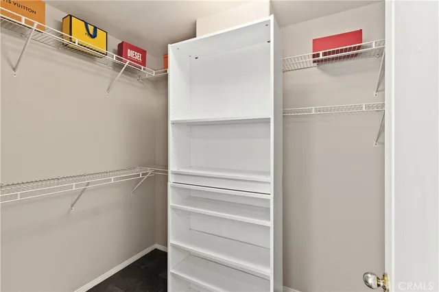 a view of walk in closet with empty racks