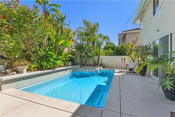 a view of backyard with outdoor seating and plants