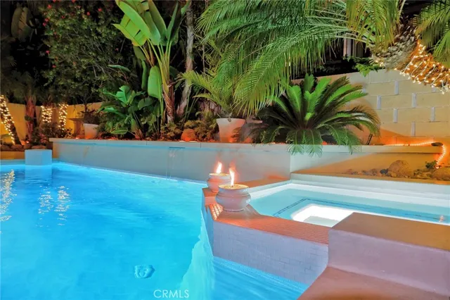 a view of backyard with swimming pool and outdoor seating