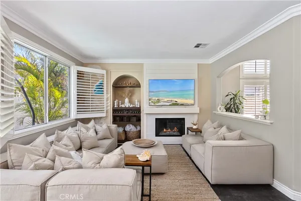 a living room with furniture fireplace and window