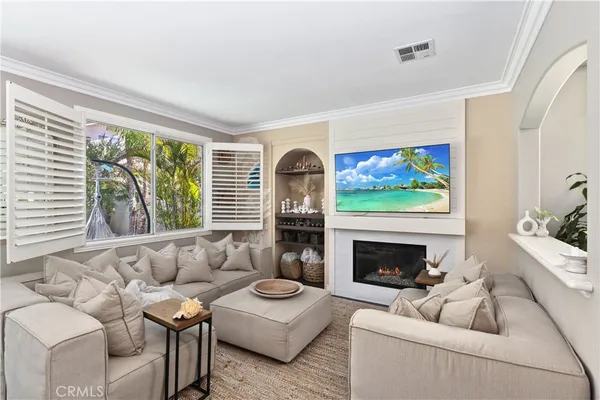 a living room with furniture a fireplace and a flat screen tv