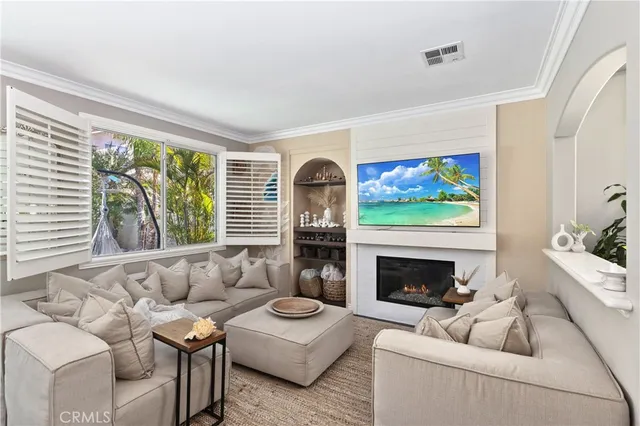 a living room with furniture a fireplace and a flat screen tv