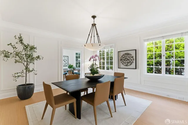 a view of a roof deck with couches and wooden floor