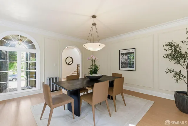 a bedroom with two beds and painting on the wall