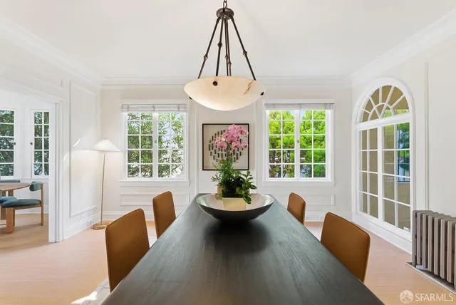 a bedroom with two beds and painting on the wall