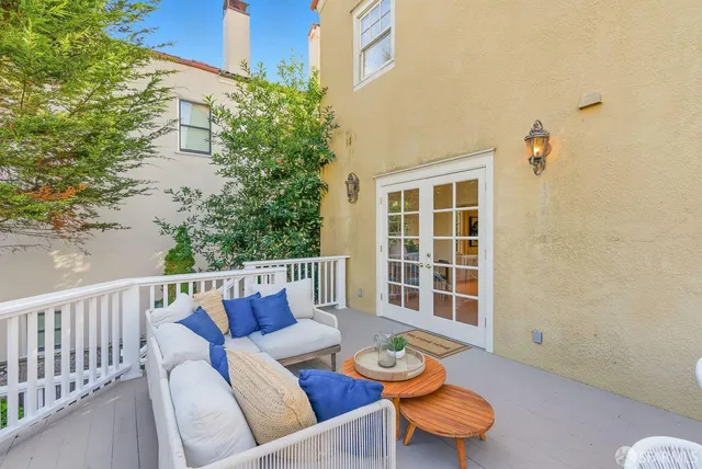 a spacious bedroom with bed and a couch with window