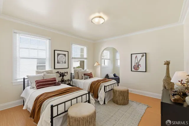 a white couch sitting in front of a window