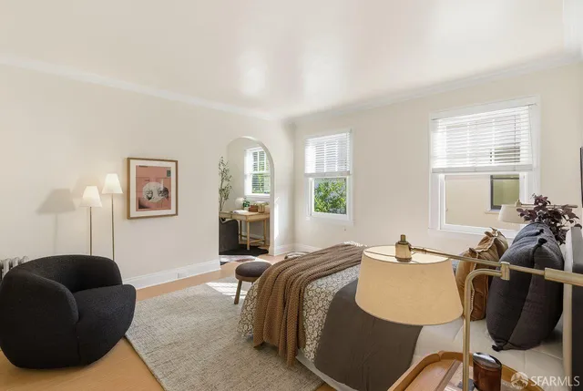 a bedroom with a bed and a lamp on the dresser