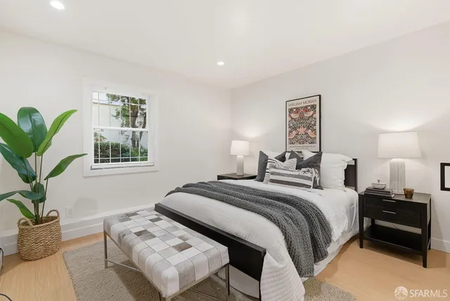 a living room with furniture gym equipment and window
