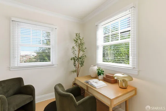 a view of a patio with a table and chairs plants and large trees