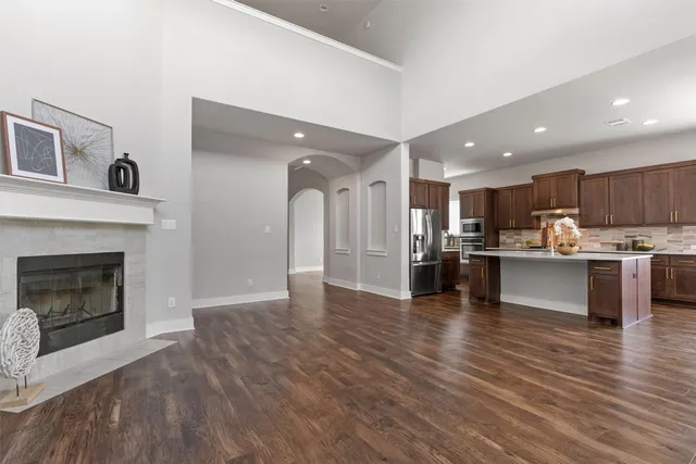 a view of kitchen with kitchen island wooden floor center island and appliances