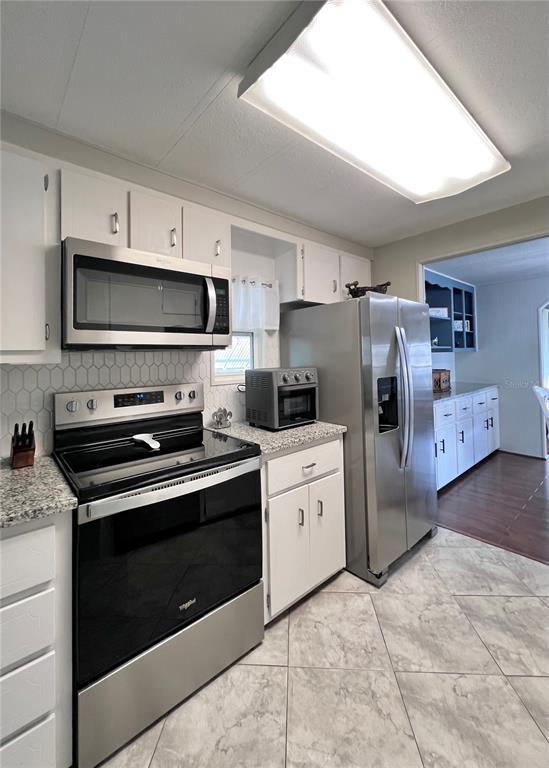 1100 South Belcher Road, Unit 772 Largo, FL 33771 - Photo 25 of 84 a kitchen with stainless steel appliances a stove microwave and refrigerator