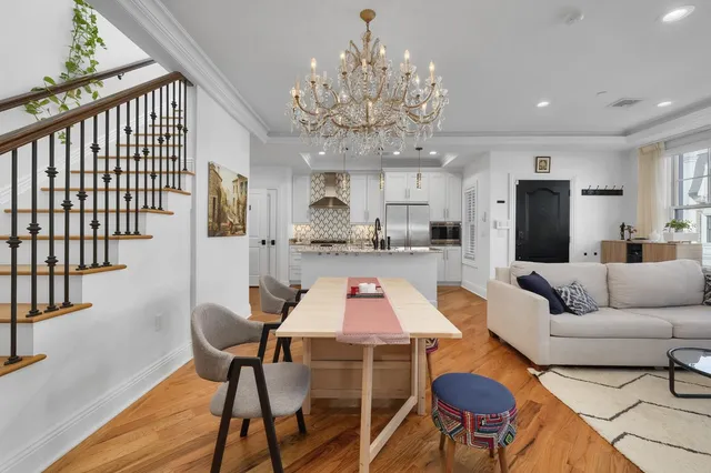 a living room with furniture and a chandelier