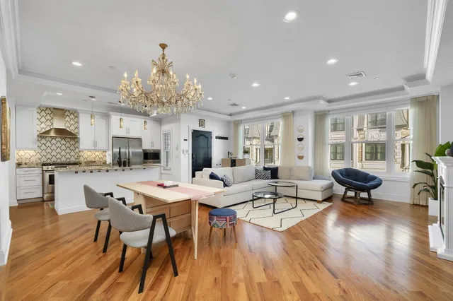 a living room with furniture and view of kitchen