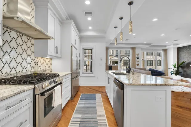a kitchen with stainless steel appliances granite countertop a stove and a sink