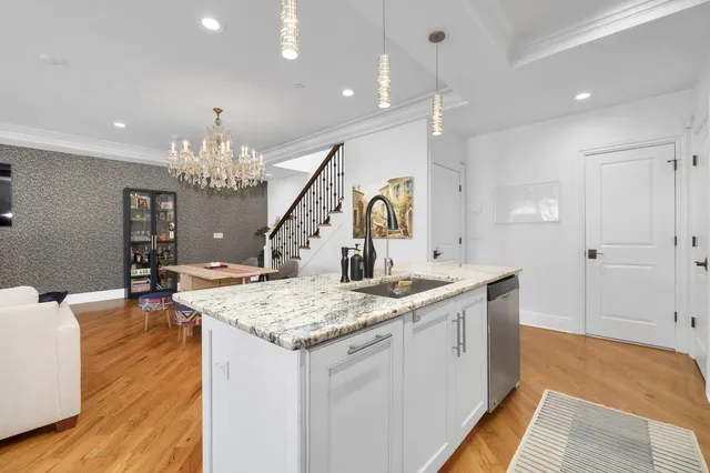 a view of a kitchen center island and living room