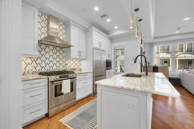 a kitchen with stainless steel appliances granite countertop a stove and a sink