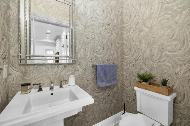 a bathroom with a sink mirror and toilet