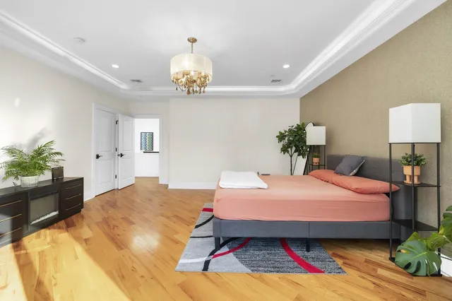 a bedroom with a bed and chandelier
