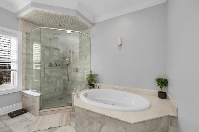 a white bath tub sitting next to a shower