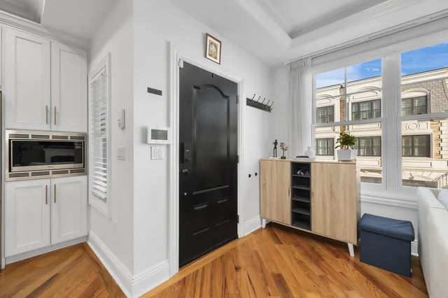 a view of kitchen with refrigerator and wooden floor