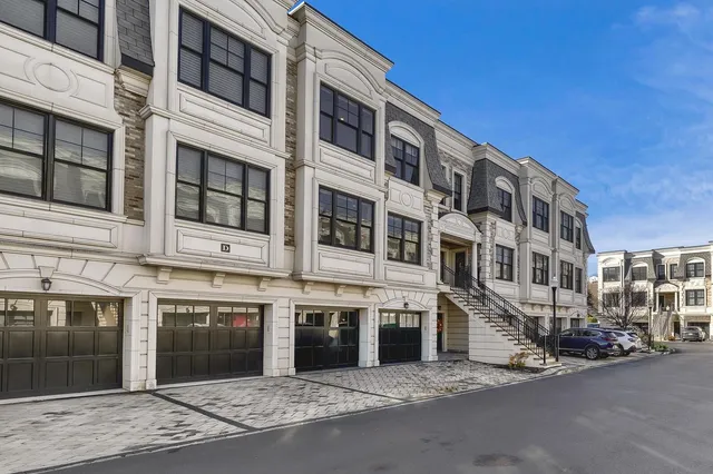 a city street lined with buildings and cars parked on the street