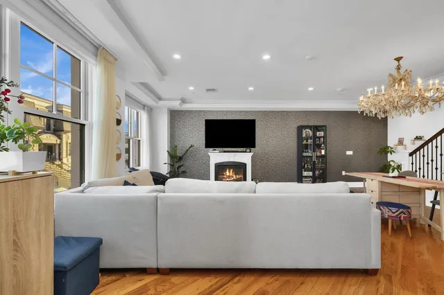 a living room with fireplace furniture and a flat screen tv