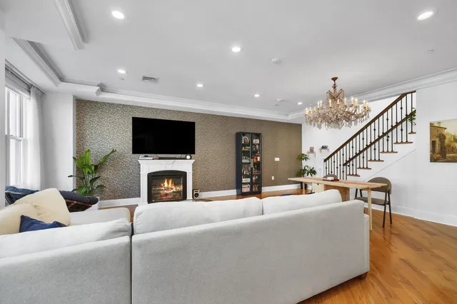 a living room with fireplace furniture and a flat screen tv