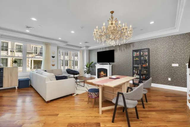 a living room with furniture a dining table and a fireplace