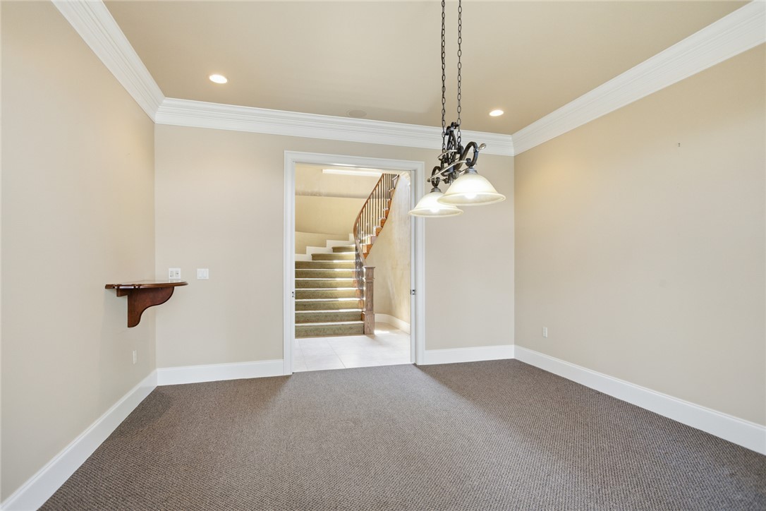 610 Highridge Drive Seneca, SC 29672 - Photo 35 of 50 This versatile room features elegant crown molding and soft carpeting, leading to a grand staircase. There's room for your pool table.
