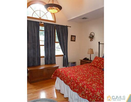 150 Kimberly Road Colonia, NJ 07067 - Photo 2 of 10 a bedroom with a bed and a window