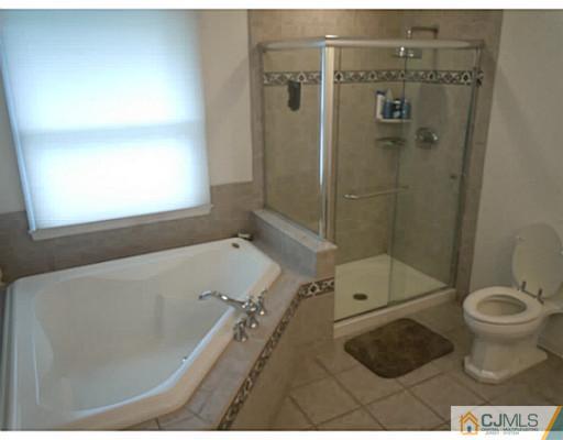 150 Kimberly Road Colonia, NJ 07067 - Photo 3 of 10 a bathroom with a toilet and a shower