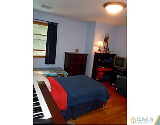 150 Kimberly Road Colonia, NJ 07067 - Photo 5 of 10 a bedroom with a bed and a window