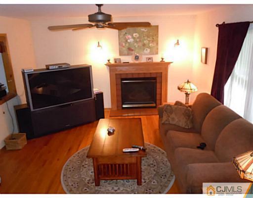 150 Kimberly Road Colonia, NJ 07067 - Photo 6 of 10 a living room with furniture and a fireplace