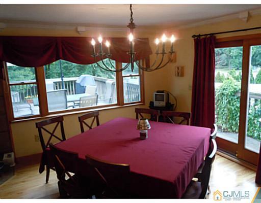 150 Kimberly Road Colonia, NJ 07067 - Photo 7 of 10 a bedroom with a bed a large window with table and chairs