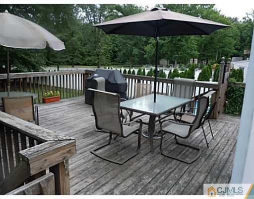 150 Kimberly Road Colonia, NJ 07067 - Photo 8 of 10 a view of balcony with wooden floor outdoor seating and yard