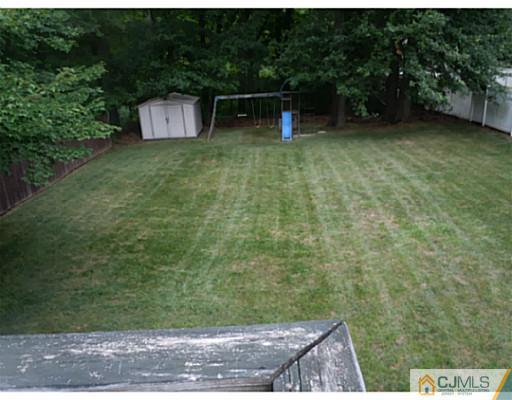 150 Kimberly Road Colonia, NJ 07067 - Photo 10 of 10 a backyard of a house with lots of green space